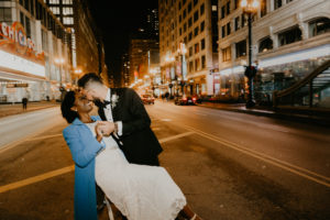 A couple kissing on a street captured by a Chicago wedding photographer.