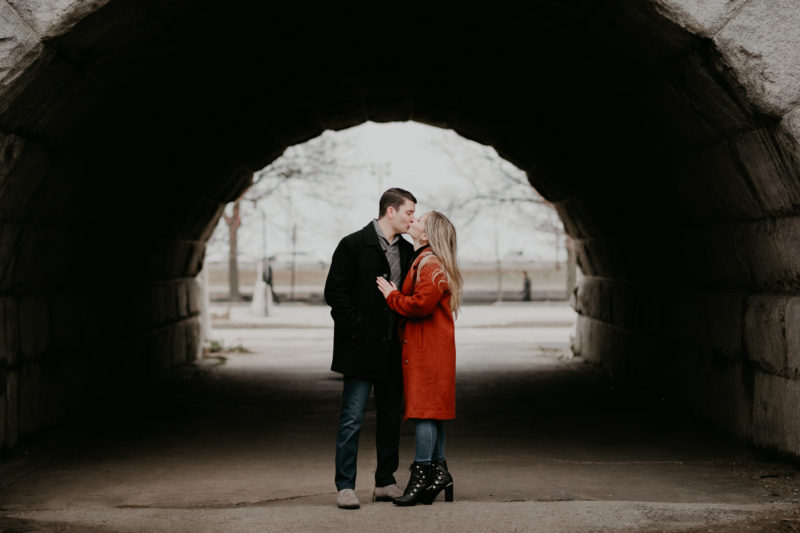 A couple kisses in a tunnel during their engagement session captured by beloveful photography.